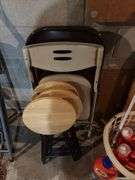 Three round folding stools and two folding chairs