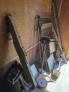 Grapple hay forks, old car tires (3pr), steel wheel, hand crank sheep shear head, old steel baby crib, primitive homemade stilts