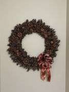 Large pine cone wreath, located over basement stairs Buyer will need to get down