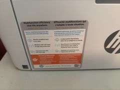 Two drawer letter file cabinet, HP LaserJet M140we printer and plastic stackable baskets