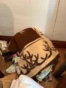 Various linens include blankets, pillows, sheets, rug
