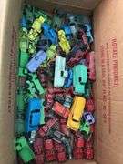 Box of toy cars, many appear to be Tootsie Toys