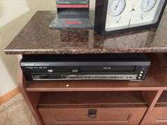 TV stand 19D x 42L x 24H, VHS/DVD player, tapes, CDs, clock/thermometer/humidistat