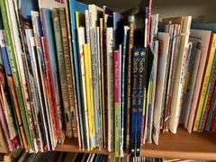 2 shelves of mostly kids books and young readers books