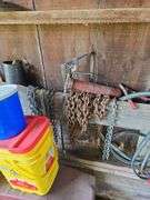 Car ramps, log chain, tire chains, scoop shovel, grease gun, large roll of plastic sheeting