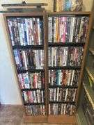 Two shelves full of DVDs and CDs