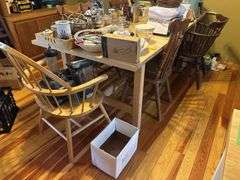 Large light pine dining room table with one self storing leaf and 5 mismatched chairs