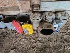 Oil, old gas cans, buckets, cast iron skillet, nails and more All on and under shelf
