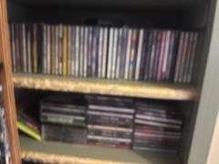 Two shelves full of DVDs and CDs
