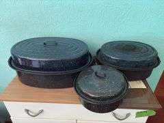 Three granite ware roasters and a hot food tray