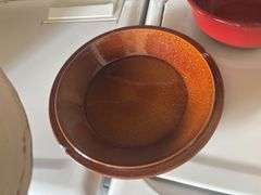 Three colored mixing bowls and apple themed pie carrier