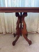 Antique walnut parlor table with original porcelain casters 20 x 31
