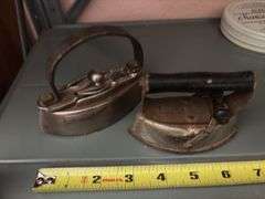 Hansen Model 2000 utility scale, two small sad irons, butter pat mold, Manson Tape tin, husking pegs