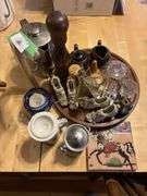 Decorative items on wooden tray, glass shoes, trivet, glassware, cream and sugar etc