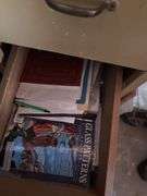 Four drawer file cabinet full of glass pieces