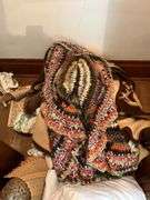 Various linens include blankets, pillows, sheets, rug