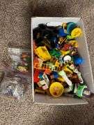 Box of assorted Fisher Price people and animals along with a bunch of other small toy items