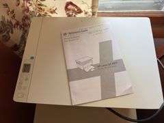 Two drawer letter file cabinet, HP LaserJet M140we printer and plastic stackable baskets