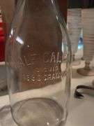 Half gallon milk bottle and cream spoon and painted jar