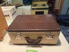 Vintage suitcase, picnic basket and wooden Coast to Coast level