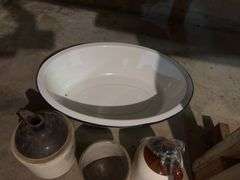 Large enamel tub with artificial flowers, two brown top jugs and a small crock