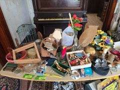 On top of table includes wooden clothes pins, old spectacles, rosaries, pottery, etc