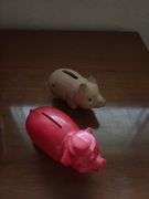 Three piggy banks and one pig with Grand Rapids Minnesota advertising