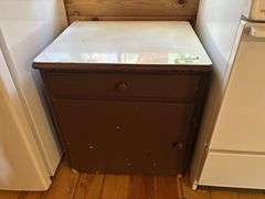 Small cupboard with enamel top and some cookware