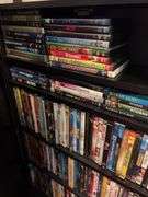 160+ DVDs and storage cabinet