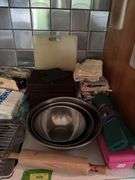 Kitchen scrubbers, rolling pins, mixing bowls, serving trays, hand towels, etc and a drawer of kitchen utensils