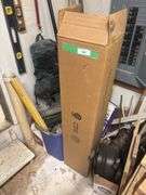 Corner of shop, including large box of new fluorescent bulbs