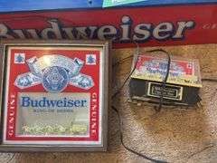 Three lighted Budweiser signs large sign does have some damage