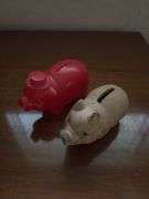 Three piggy banks and one pig with Grand Rapids Minnesota advertising