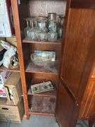 Two storage cupboards (one missing handle) and glassware contents