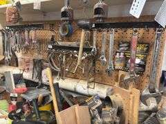 Large quantity of hand tools on top of bench
