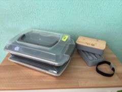 Two cake pans with lids and lunch kit