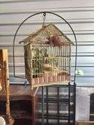 Antique cast-iron birdcage holder with vintage wooden cage