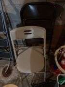 Three round folding stools and two folding chairs