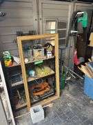 Side wall of garden storage shed includes camp table, electric blower, and string trimmer - shelving unit not included