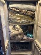 Double door plastic storage cupboard and contents - mostly blankets and linens