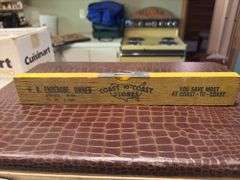 Vintage suitcase, picnic basket and wooden Coast to Coast level