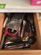 Kitchen scrubbers, rolling pins, mixing bowls, serving trays, hand towels, etc and a drawer of kitchen utensils