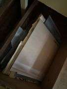 Four drawer file cabinet full of glass pieces