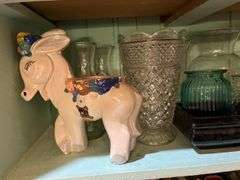 Contents of cupboard include vases, coffee mugs, TV lamp, etc