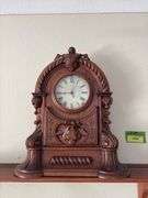 Antique walnut key wind shelf clock, very ornate carved case. Not sure if American or European ???