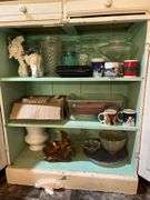 Contents of cupboard include vases, coffee mugs, TV lamp, etc