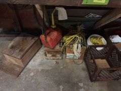 Under bench includes gas can, various ropes, empty tool case, metal sheets