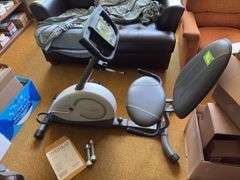 Weslo Pursuit 360R exercise bike and a pair of stainless steel dumbbells