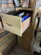 Four drawer file cabinet full of glass pieces