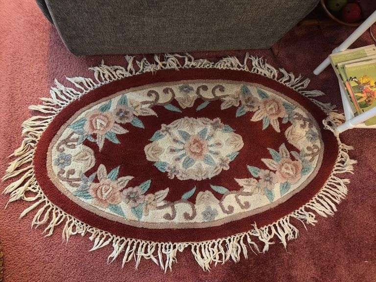 Small oval entry rug, rattan laundry hamper and linens